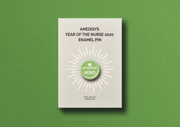 Amedisys Year of the Nurse 2020 enamel pin on its printed backing card against a green background, the pin reading Amedisys Hero.
