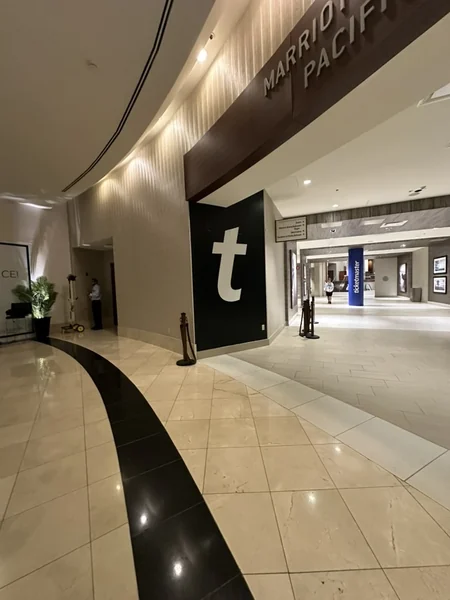 Venue concourse with a tall black Ticketmaster banner hanging above a curved walkway.