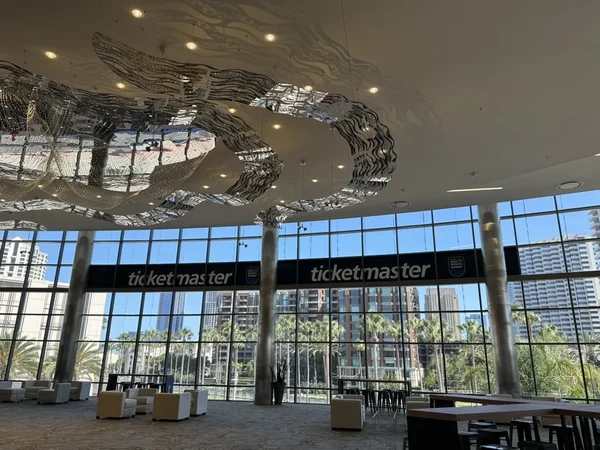 Glass entrance to the venue with the Ticketmaster name repeated across the header and a curved metallic canopy overhead.